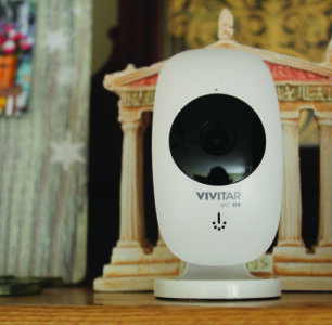 closeup of a vivitar iPC113 security camera on a shelf indoors